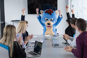 Image showing boss dresed as bear having fun with business people in trendy of