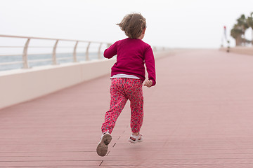 Image showing cute little girl on the promenade by the sea