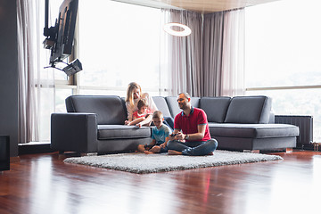 Image showing Happy family playing a video game