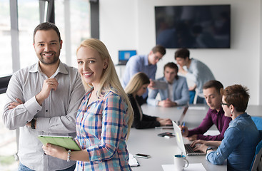 Image showing Two Business People Working With Tablet in office