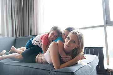 Image showing young mother spending time with kids on the floor