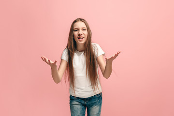 Image showing Beautiful female half-length portrait on pink studio backgroud. The young emotional teen girl