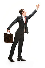 Image showing Choose me. Full body view of businessman on white studio background