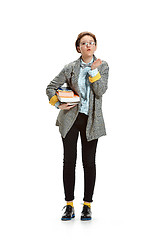 Image showing Full length portrait of a happy smiling female student holding books isolated on white background