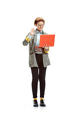 Image showing Full length portrait of a happy smiling female student holding notebook isolated on white background