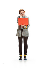 Image showing Full length portrait of a happy smiling female student holding notebook isolated on white background