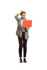 Image showing Full length portrait of a happy smiling female student holding notebook isolated on white background