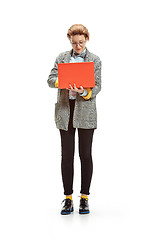 Image showing Full length portrait of a happy smiling female student holding notebook isolated on white background