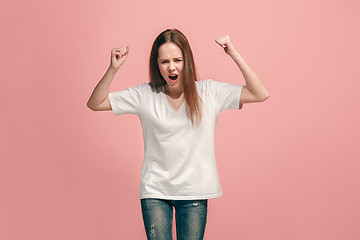 Image showing Portrait of angry teen girl on a pink studio background