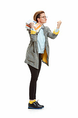 Image showing Full length portrait of a angry female student holding books isolated on white background