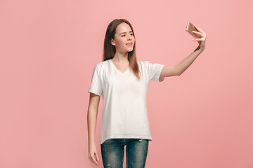 Image showing The happy teen girl making selfie photo by mobile phone