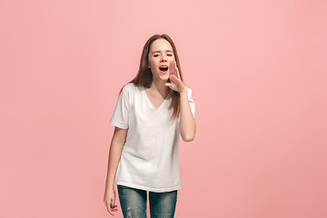Image showing young casual teen girl shouting at studio