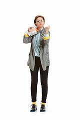 Image showing Full length portrait of a angry female student holding books isolated on white background