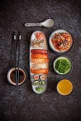 Image showing Asian food assortment. Various sushi rolls placed on ceramic plates