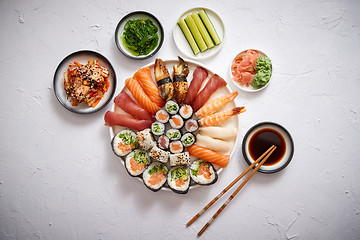 Image showing Various sushi rolls placed on round ceramic plate