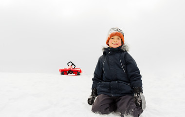 Image showing happy boy and sled on snow hill in winter