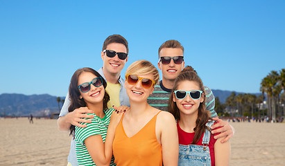 Image showing friends in sunglasses over white background