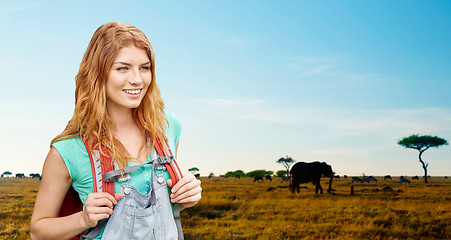 Image showing happy woman with backpack over african savannah