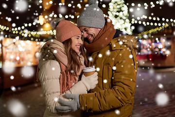 Image showing happy young couple with coffee at christmas market