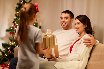 Image showing happy family with christmas present at home