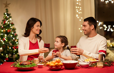 Image showing happy family having christmas dinner at home