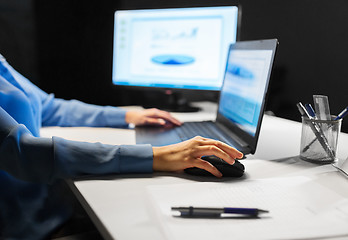 Image showing close up of female hand using computer mouse