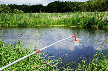 Image showing Take samples of water for laboratory testing. The concept - analysis of water purity, environment, ecology.