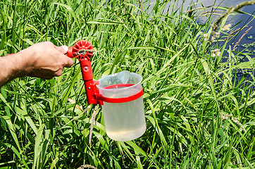 Image showing Take samples of water for laboratory testing. The concept - analysis of water purity, environment, ecology.