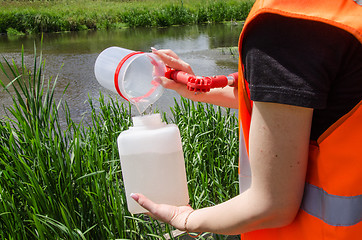 Image showing Take samples of water for laboratory testing. The concept - analysis of water purity, environment, ecology.