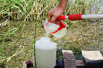 Image showing Take samples of water for laboratory testing. The concept - anal