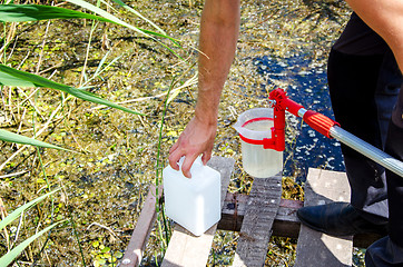 Image showing Take samples of water for laboratory testing. The concept - anal