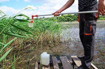 Image showing Take samples of water for laboratory testing. The concept - anal