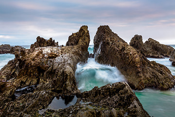 Image showing Ocean waves pushing through the dramatic jagged rock gap channel