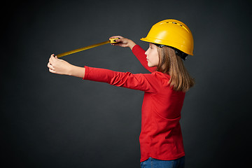 Image showing Decoration, renovation and reconstrucion concept. Girl with measuring tape