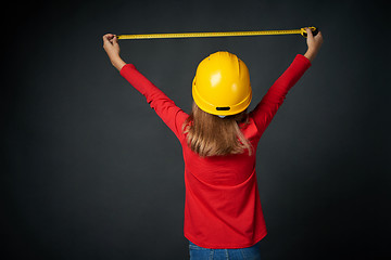 Image showing Decoration, renovation and reconstrucion concept. Girl with measuring tape