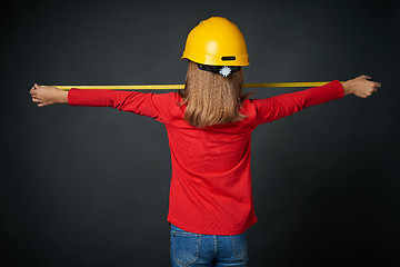 Image showing Decoration, renovation and reconstrucion concept. Girl with measuring tape
