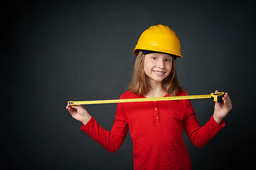 Image showing Decoration, renovation and reconstrucion concept. Girl with measuring tape