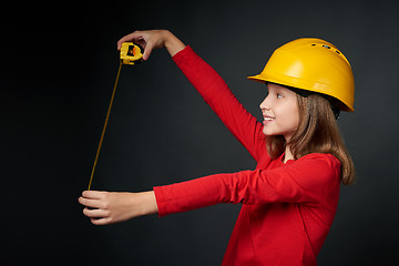 Image showing Decoration, renovation and reconstrucion concept. Girl with measuring tape