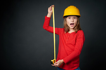 Image showing Decoration, renovation and reconstrucion concept. Girl with measuring tape