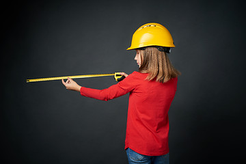 Image showing Decoration, renovation and reconstrucion concept. Girl with measuring tape