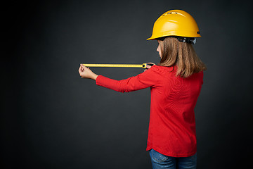 Image showing Decoration, renovation and reconstrucion concept. Girl with measuring tape