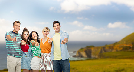 Image showing happy friends hugging and pointing at you