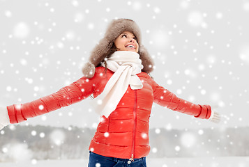 Image showing happy woman in winter fur hat outdoors