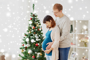 Image showing pregnant wife with husband at home at christmas