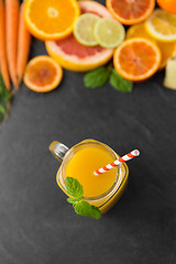 Image showing mason jar glass of fruit juice on slate table top