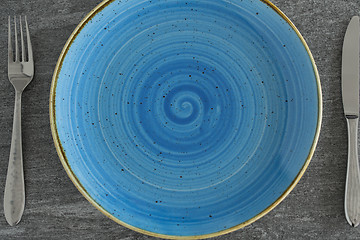 Image showing close up of plate, fork and knife on table