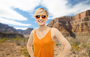 Image showing happy smiling teenage girl over grand canyon