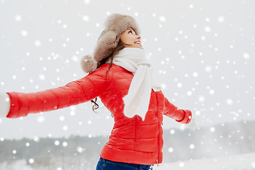 Image showing happy woman in winter fur hat outdoors