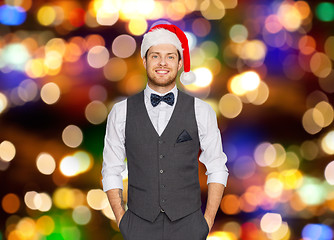 Image showing happy man in santa hat and suit at christmas