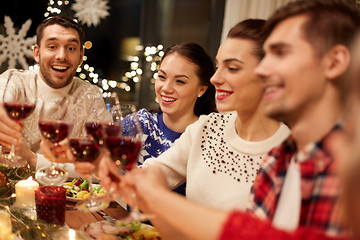 Image showing friends celebrating christmas and drinking wine